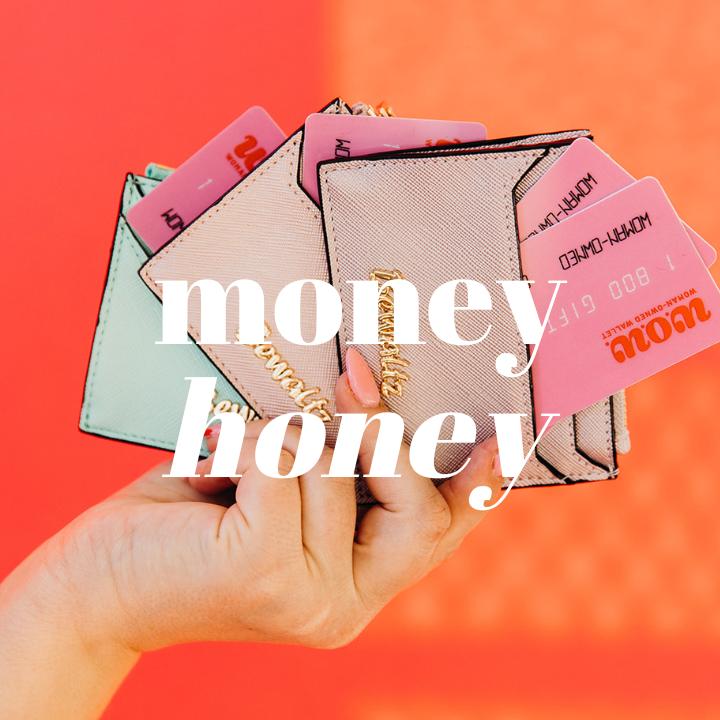 Close up of woman's hand holding three mini wallets each containing pink gift cards from Woman-Owned Wallet. The words "Money Honey" are typed in large white text in the middle of the photo.