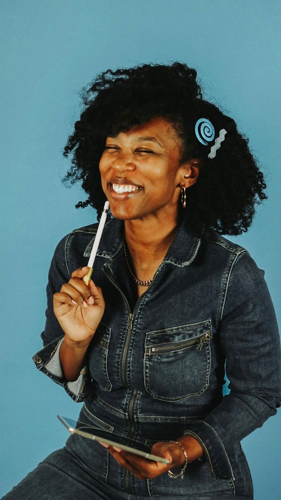 Woman holding a pen and tablet against a blue background