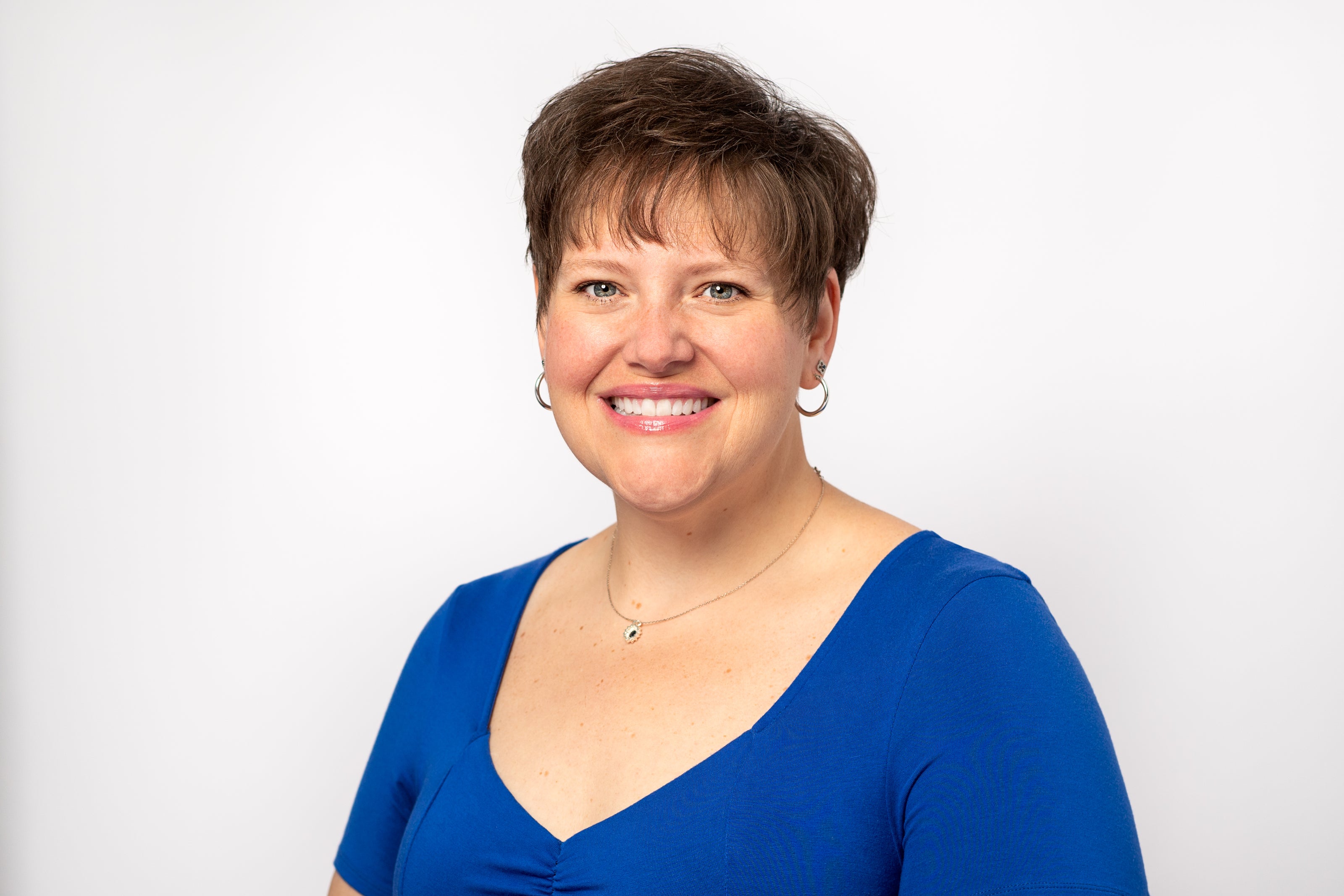 Woman wearing a blue shirt against a white background