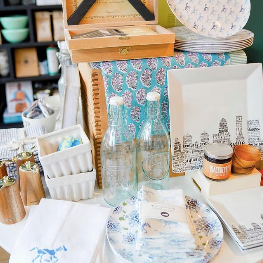 Tablescape of blue and white home decor and gifts at Jones and Daughters, a shop on the Nulu Woman-Owned Walking Tour and in the Woman-Owned Directory hosted by Woman-Owned Wallet.