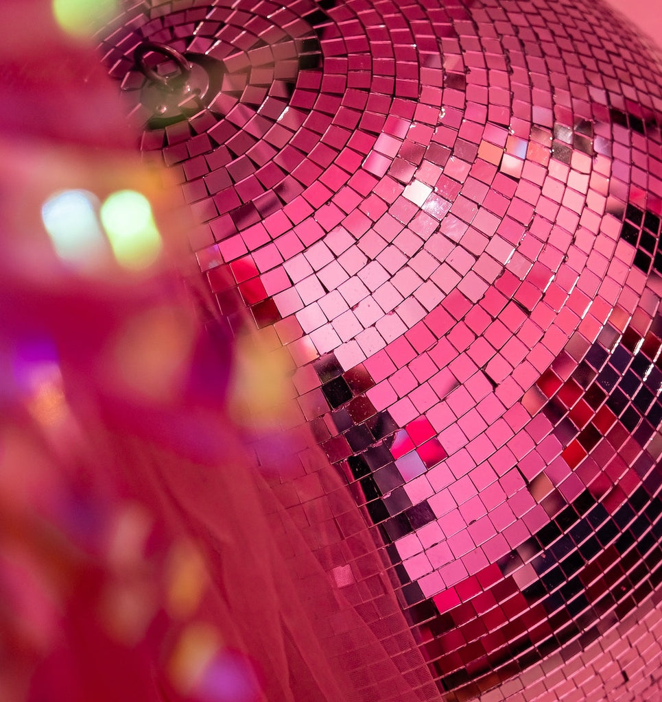 Pink disco ball. WOW World is a brand extension of Woman-Owned Wallet, a feminist gift shop in Louisville KY. WOW World is an online networking community for women.