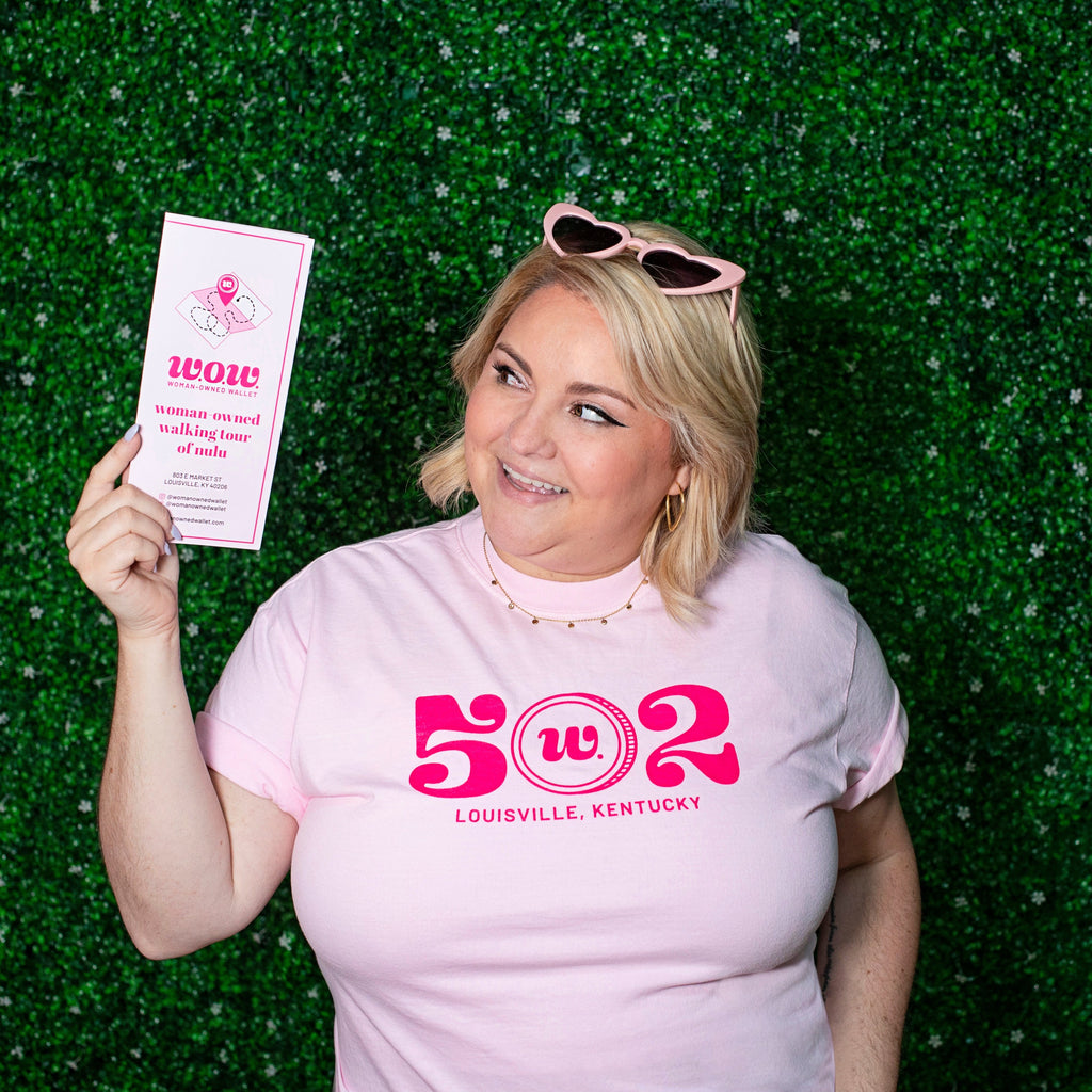 Woman wearing pink tee with "502" in large font with "Louisville Kentucky" written below.