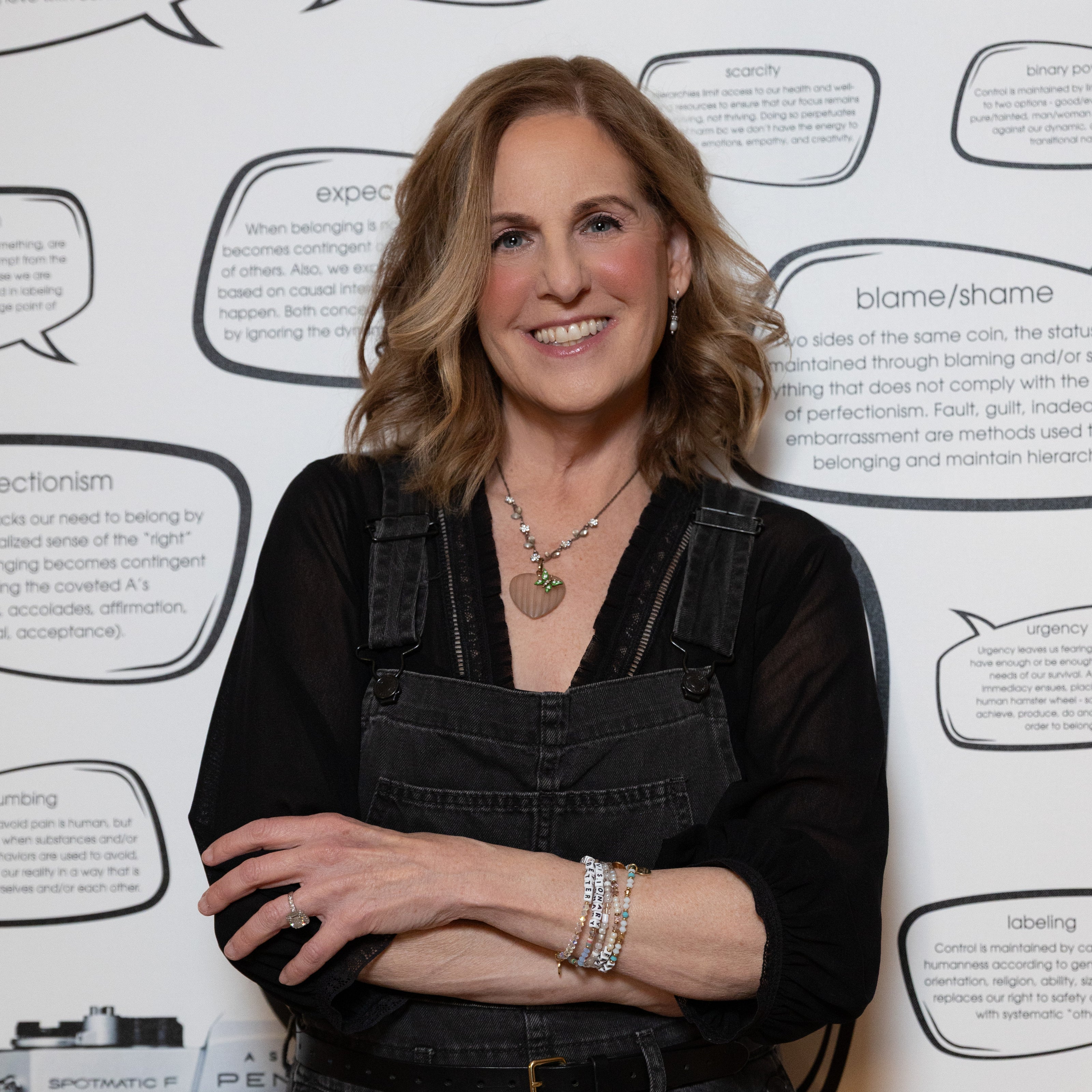 Woman standing in front of a wall with text and speech bubbles