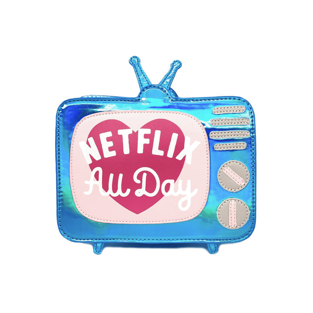Blue iridescent novelty bag that is shaped like a vintage television set. Features a pink "screen" with a dark pink heart and the words "Netflix all day". Also features silver dial knobs.