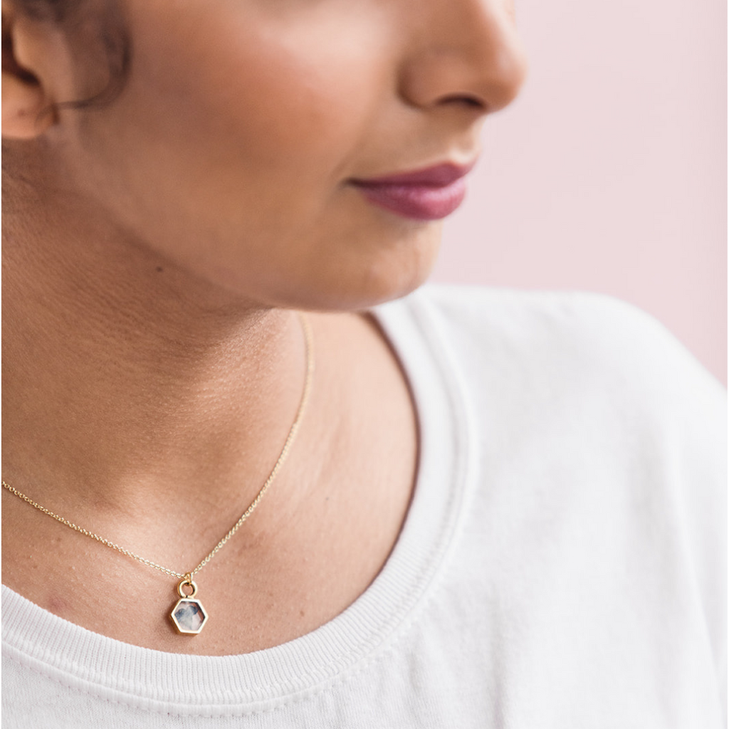 Close up of model wearing hexagon Forget Me Not Necklace