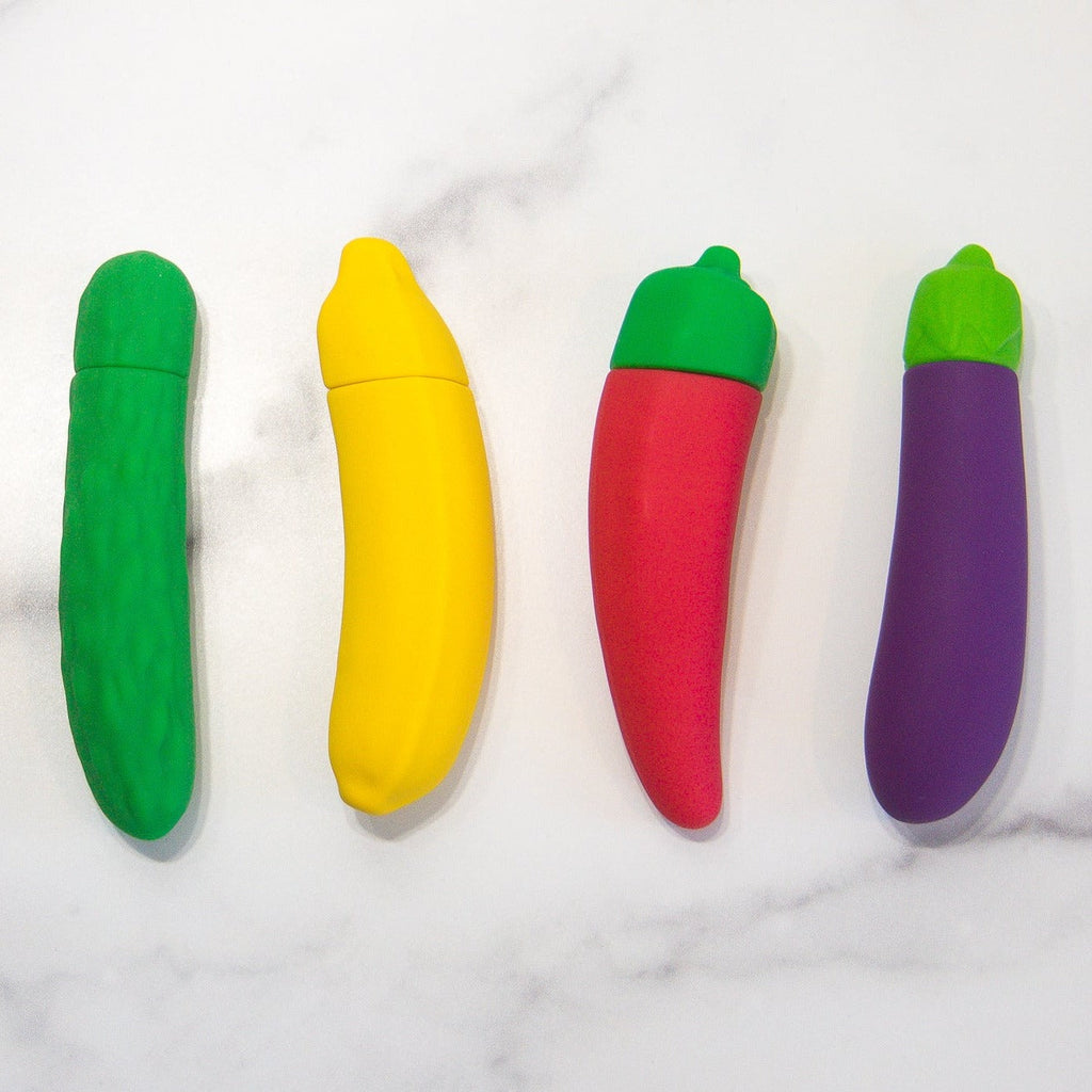 vibrators shaped like a pickle, chili pepper, banana, and eggplant all laid on a white background
