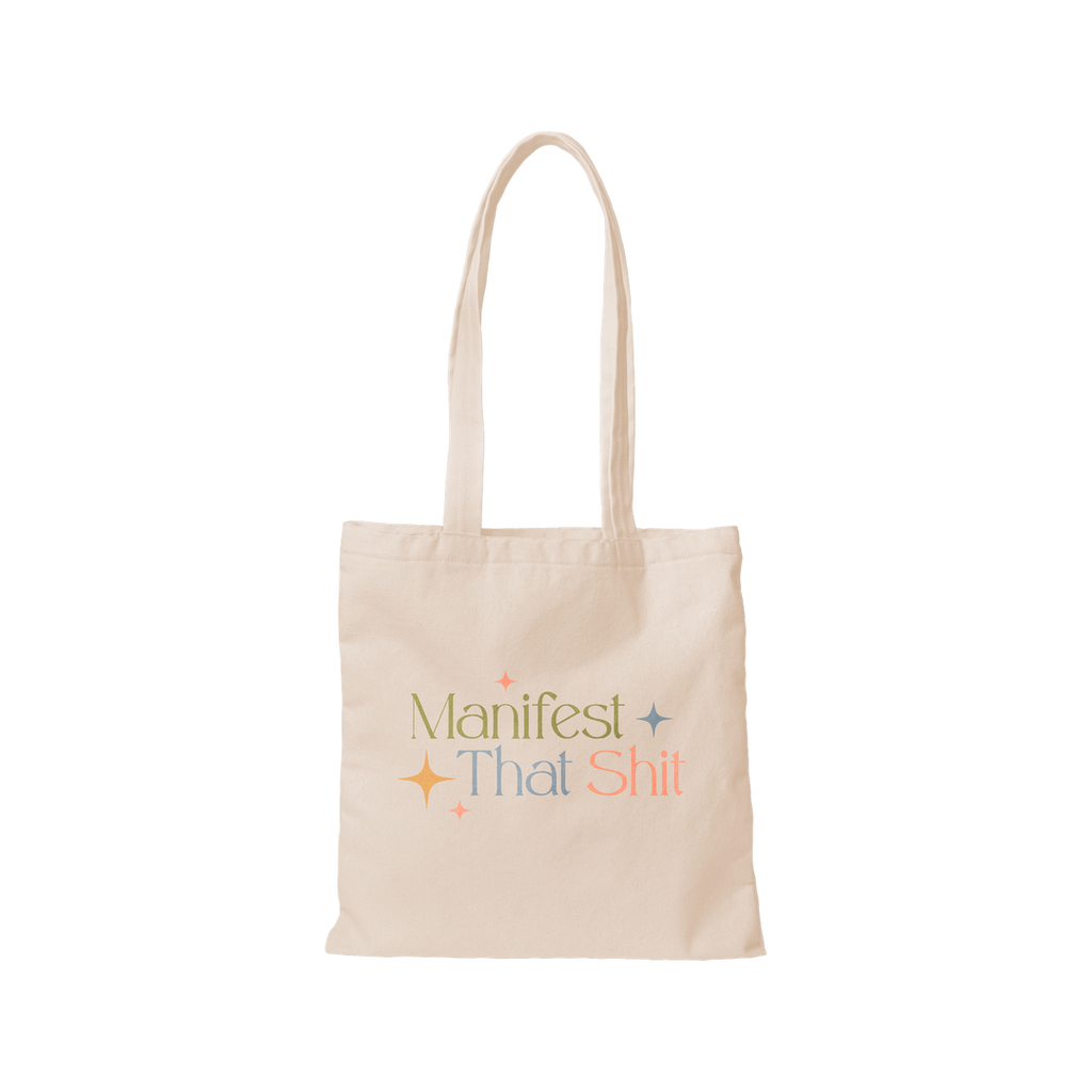 flat lay shot of natural canvas tote featuring the phrase "Manifest That Shit"